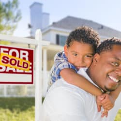 man and son with real estate sign