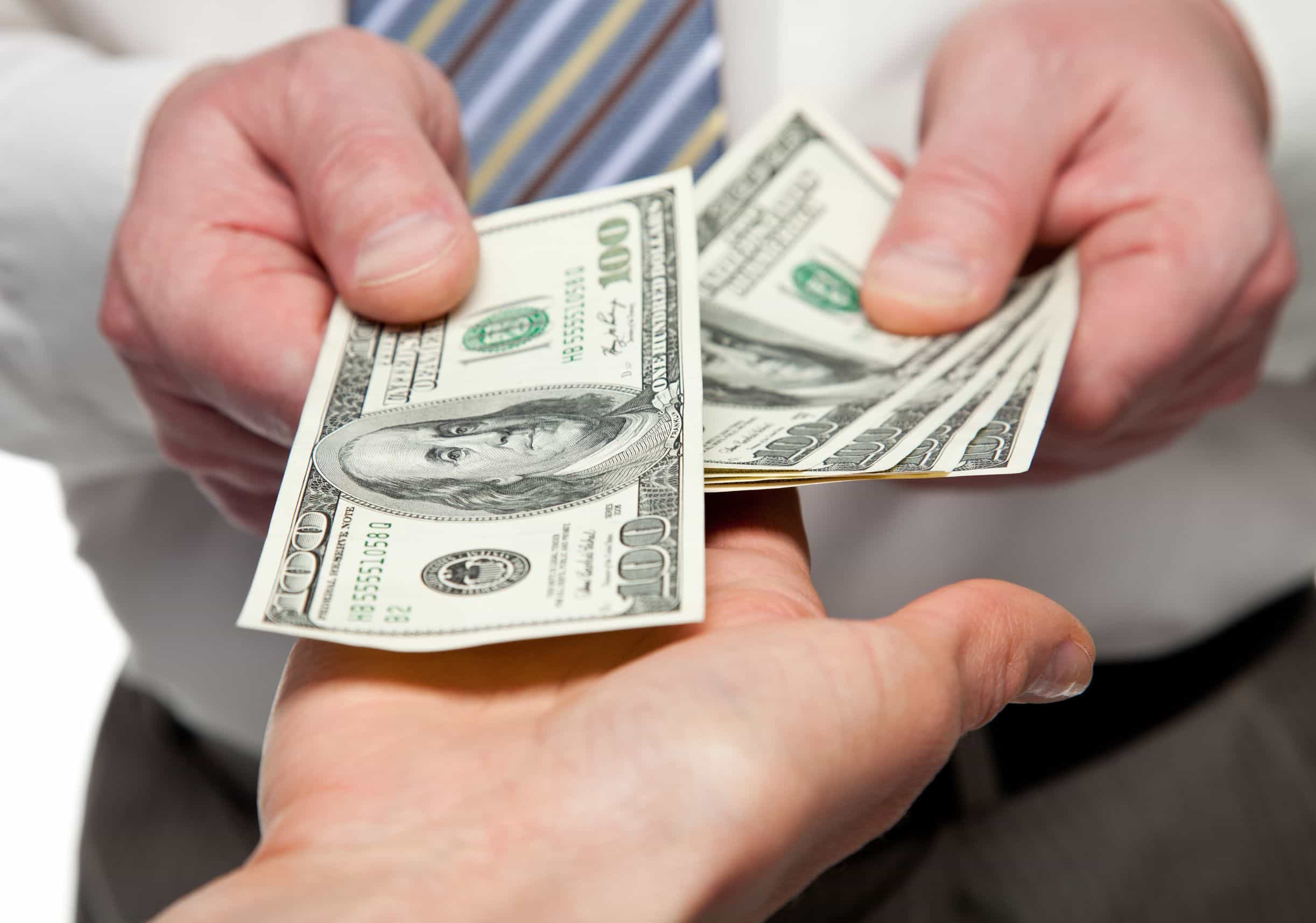 image of hands exchanging money